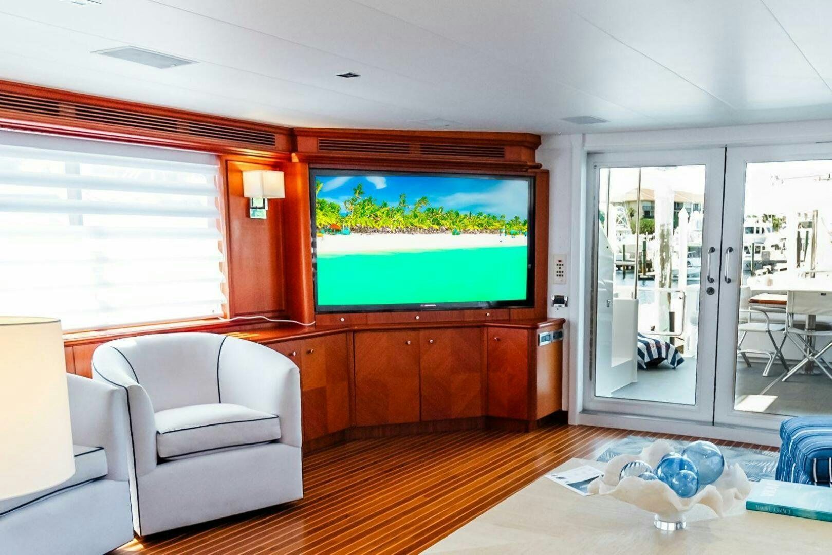 a living room with a tv aboard GRACE Yacht for Sale