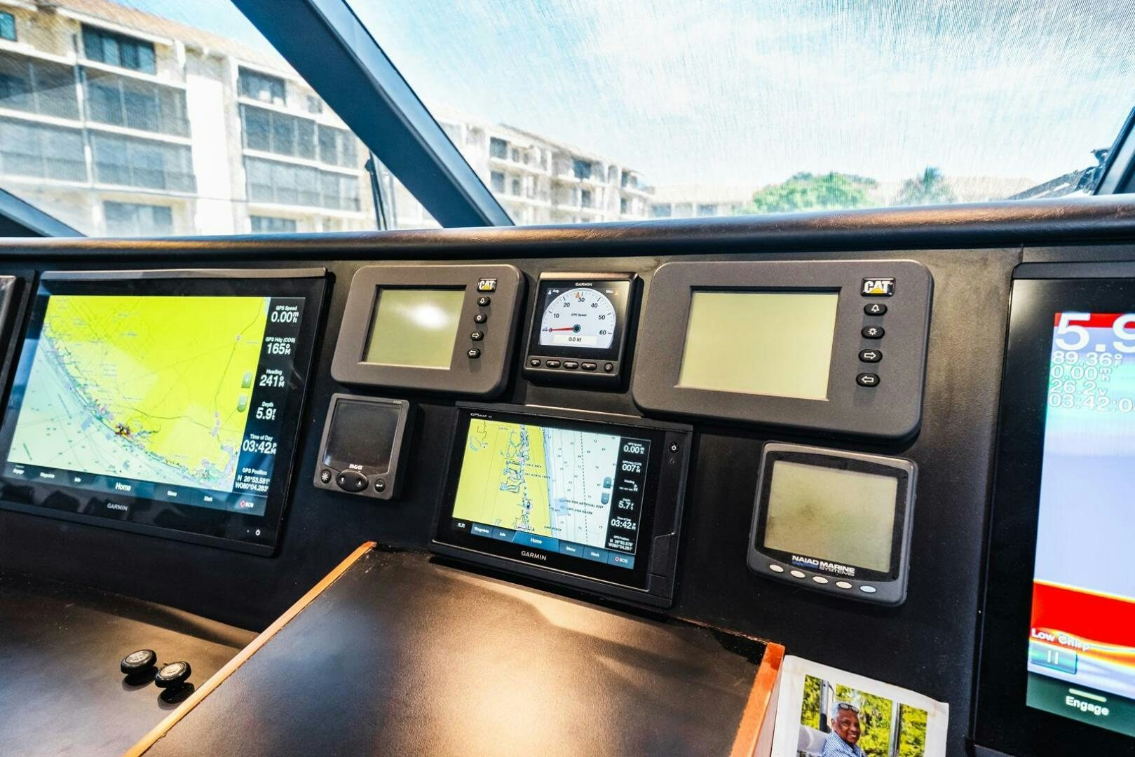 a desk with a computer and monitors aboard GRACE Yacht for Sale