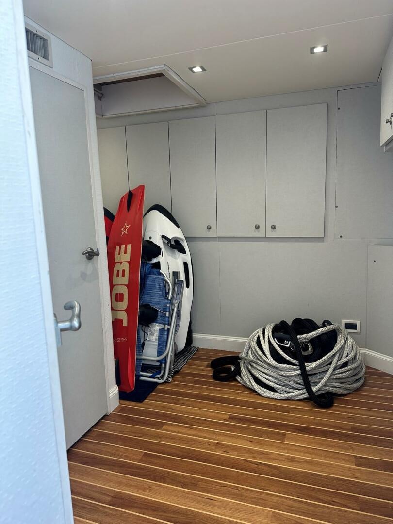 a room with a wood floor and white cabinets aboard GRACE Yacht for Sale