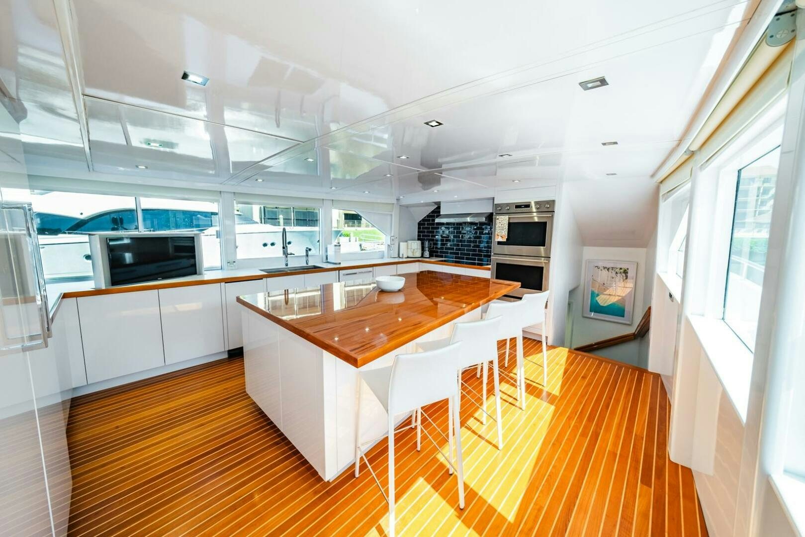 a large kitchen with a table and chairs aboard GRACE Yacht for Sale