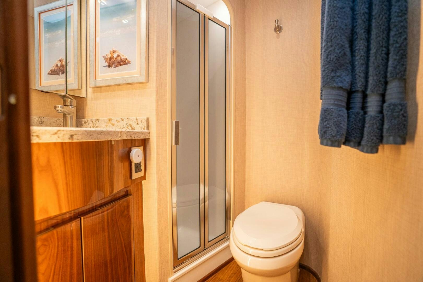 a bathroom with a toilet and a sink aboard VOODOO Yacht for Sale