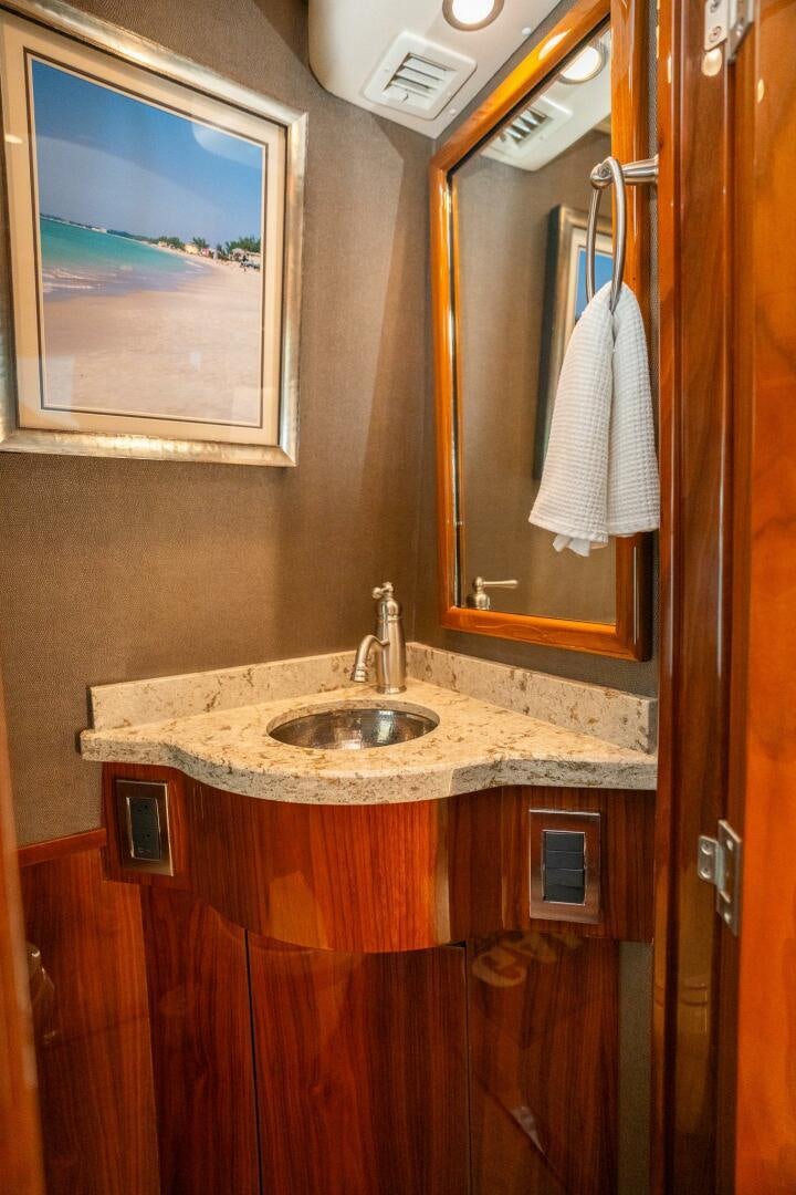a bathroom with a sink and a mirror aboard VOODOO Yacht for Sale