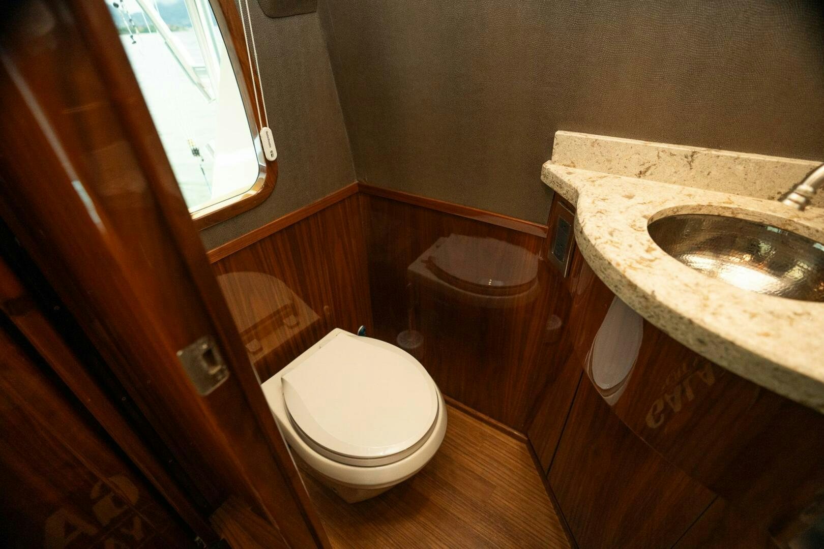a bathroom with a toilet and sink aboard VOODOO Yacht for Sale