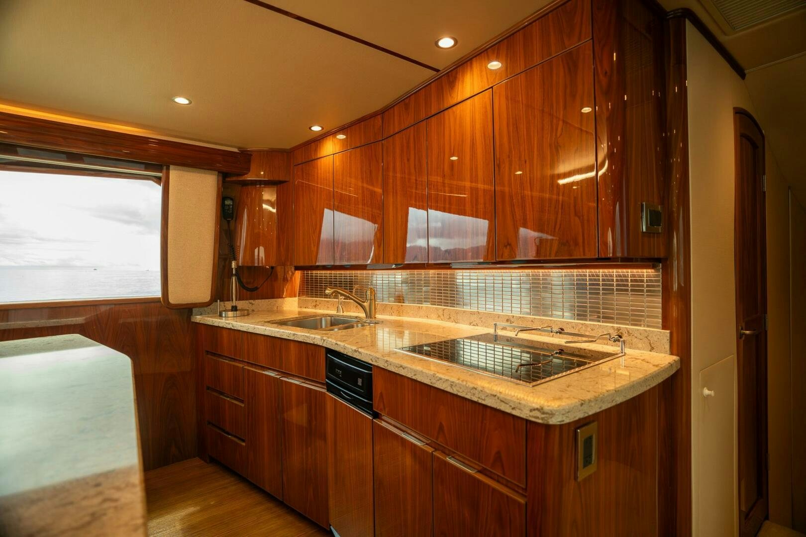 a kitchen with wooden cabinets aboard VOODOO Yacht for Sale
