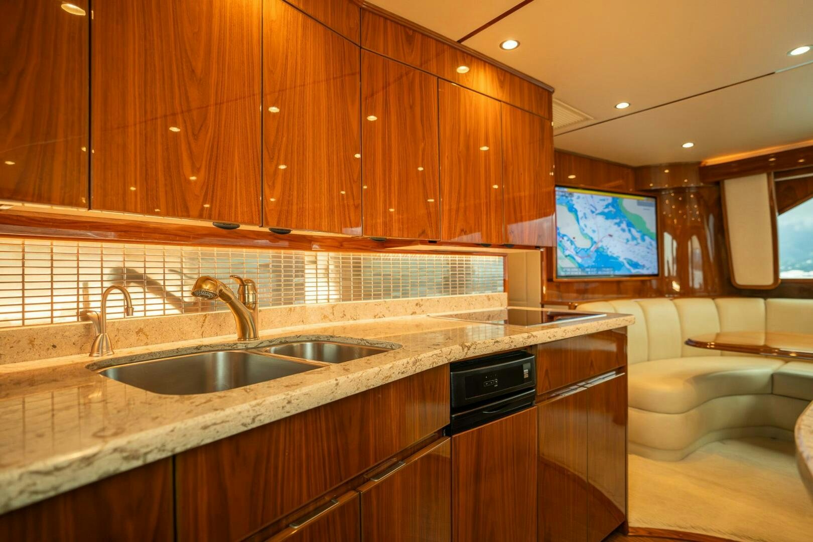 a kitchen with wooden cabinets aboard VOODOO Yacht for Sale