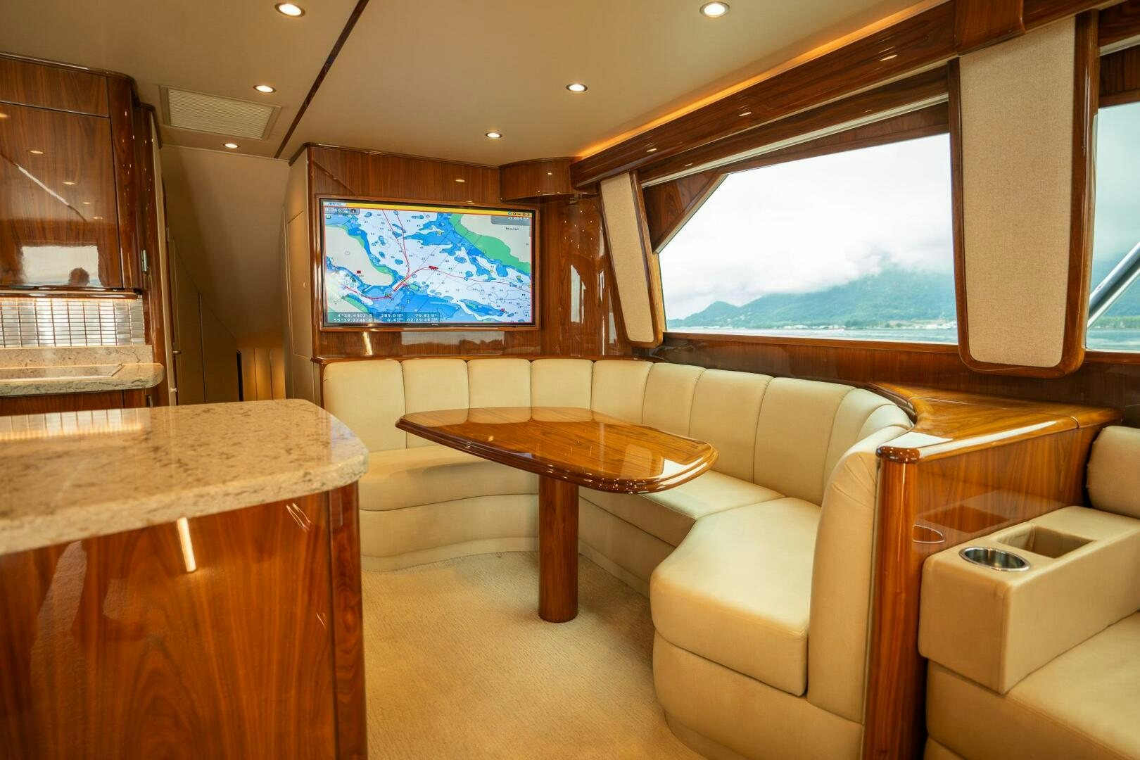 a living room with a table and chairs aboard VOODOO Yacht for Sale