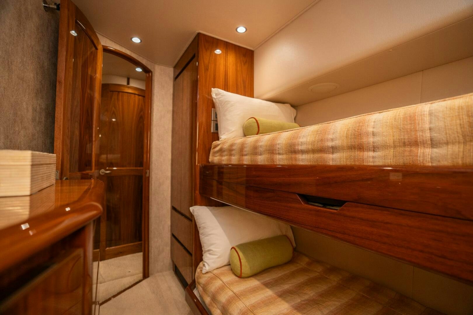 a bed with a wooden headboard aboard VOODOO Yacht for Sale