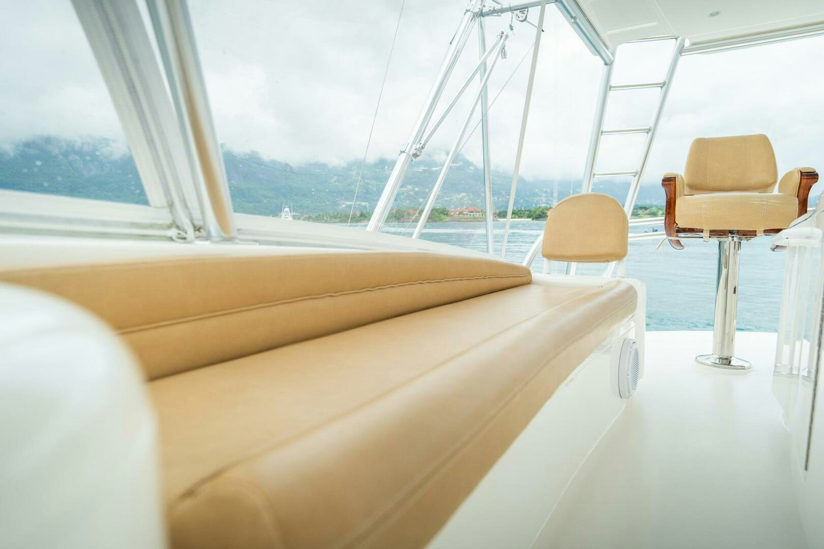 a boat with a chair and a table and chairs aboard VOODOO Yacht for Sale
