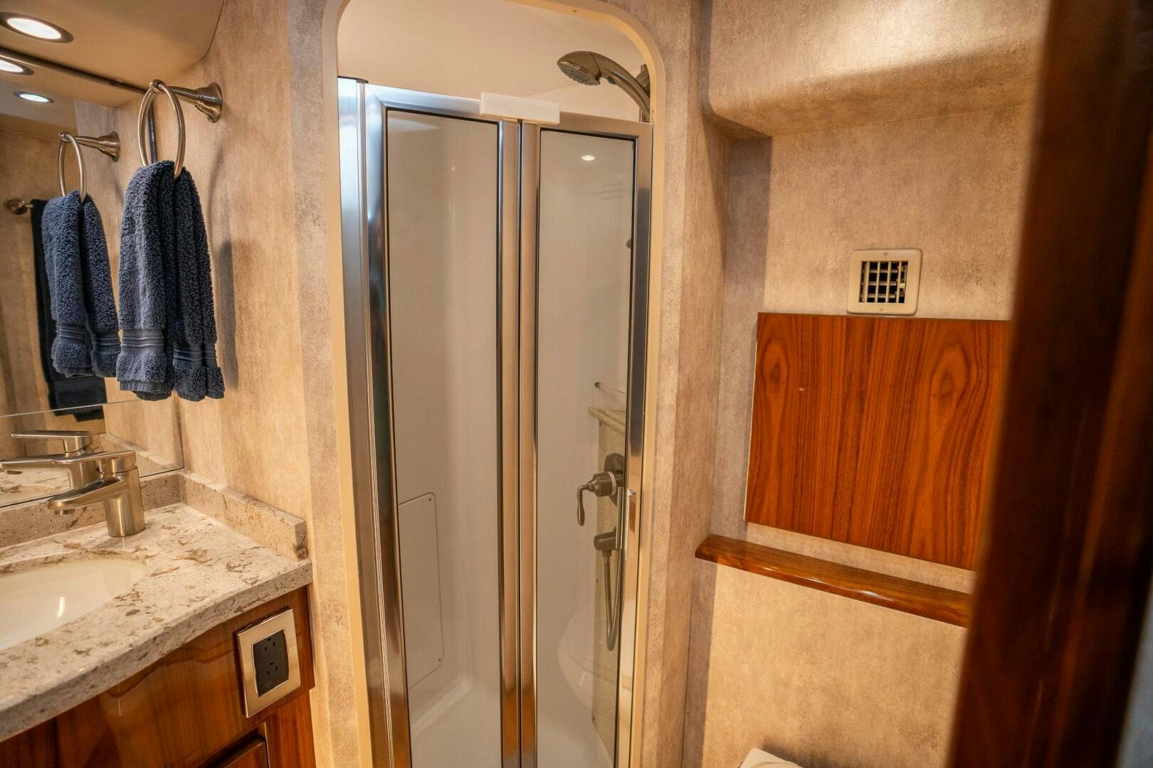 a bathroom with a glass shower door aboard VOODOO Yacht for Sale