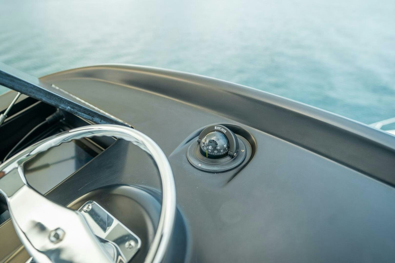 the steering wheel and dashboard of a car aboard VOODOO Yacht for Sale