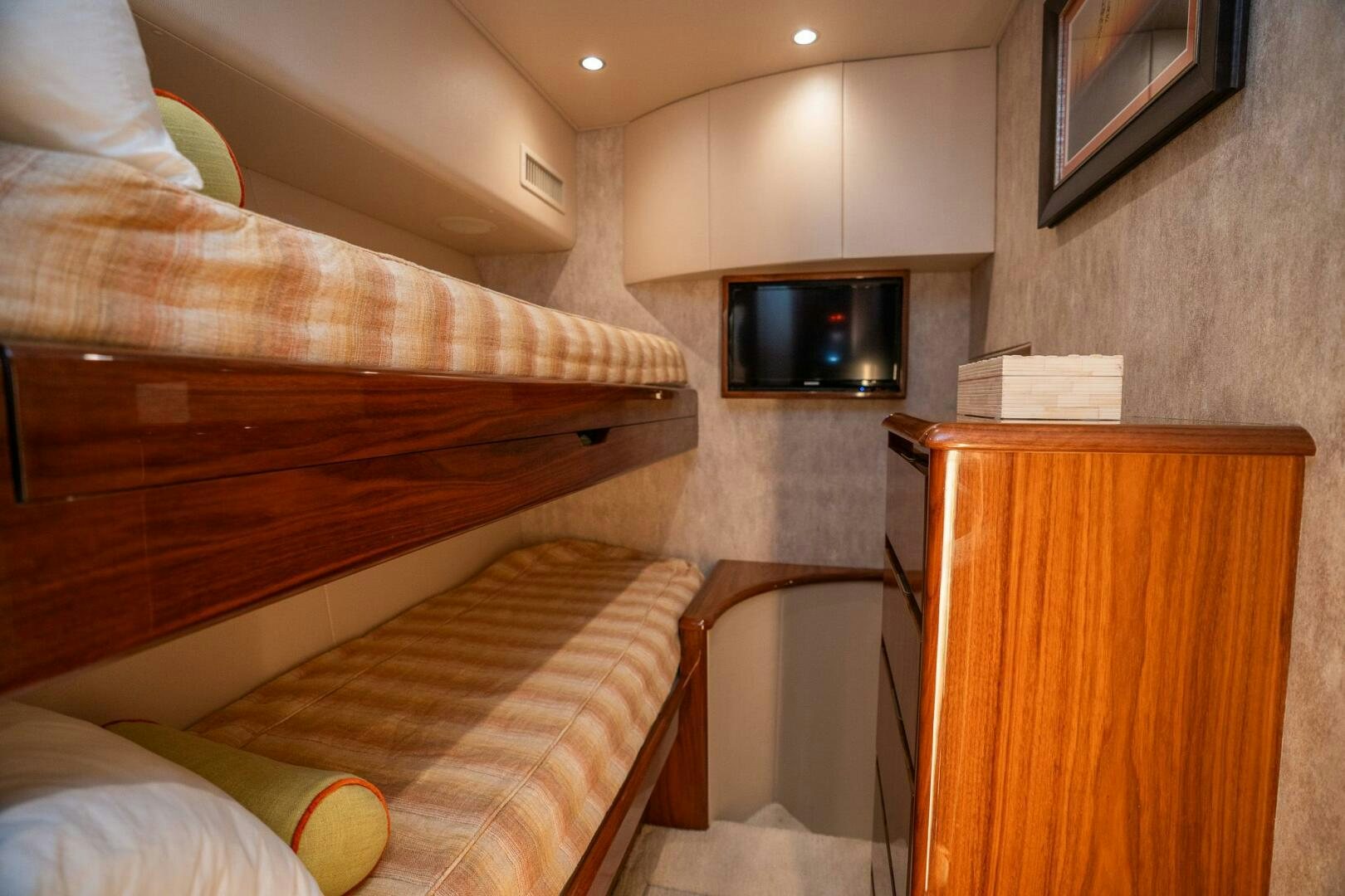 a bed and a television in a room aboard VOODOO Yacht for Sale