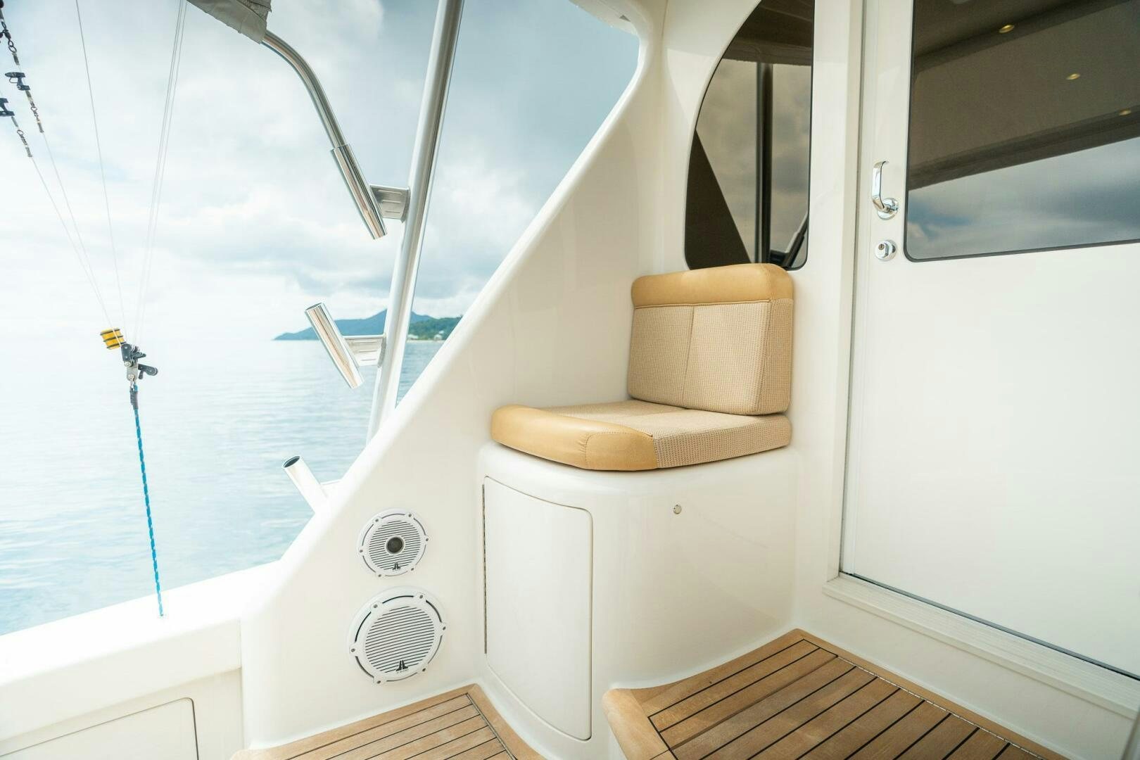 a white boat with a wooden seat aboard VOODOO Yacht for Sale