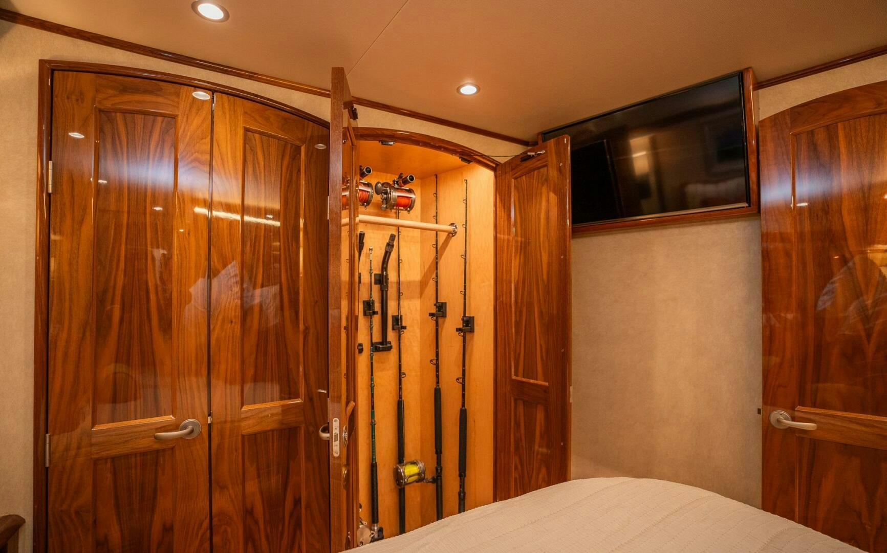 a room with a bed and a closet aboard VOODOO Yacht for Sale
