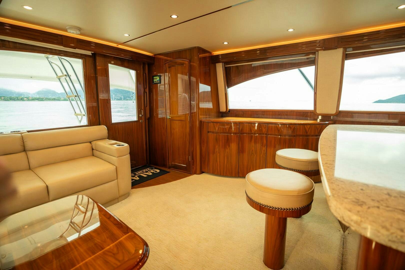 a room with a couch and a table and a window aboard VOODOO Yacht for Sale