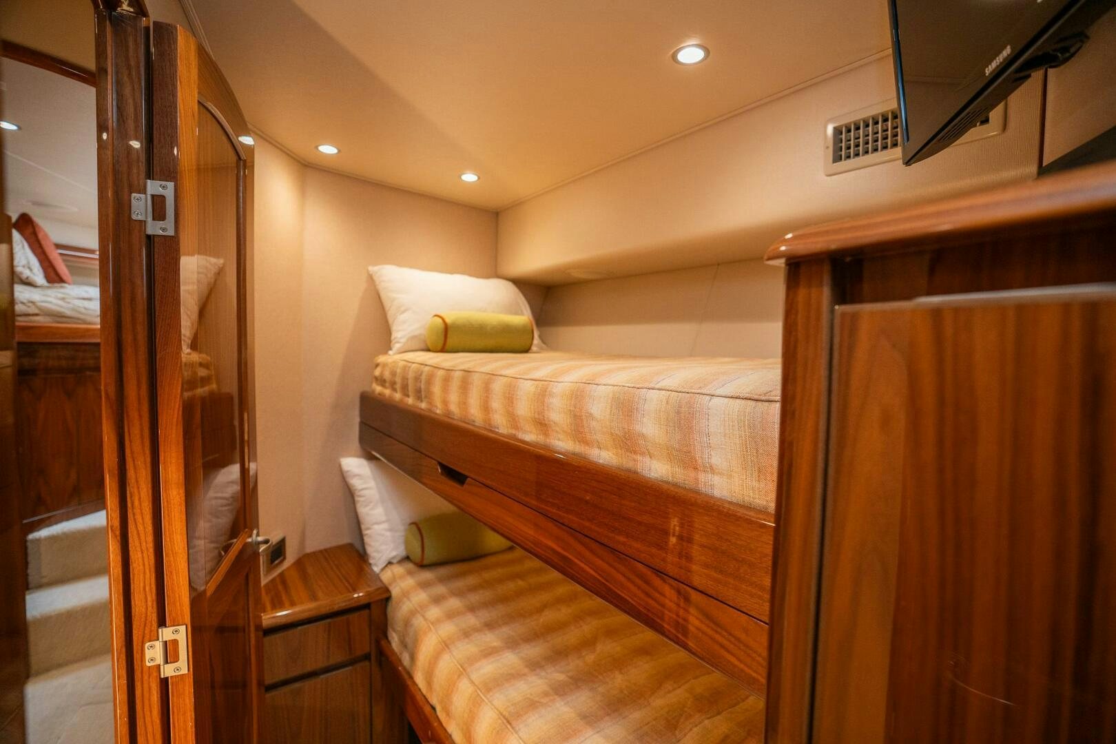 a room with a bed and a mirror aboard VOODOO Yacht for Sale