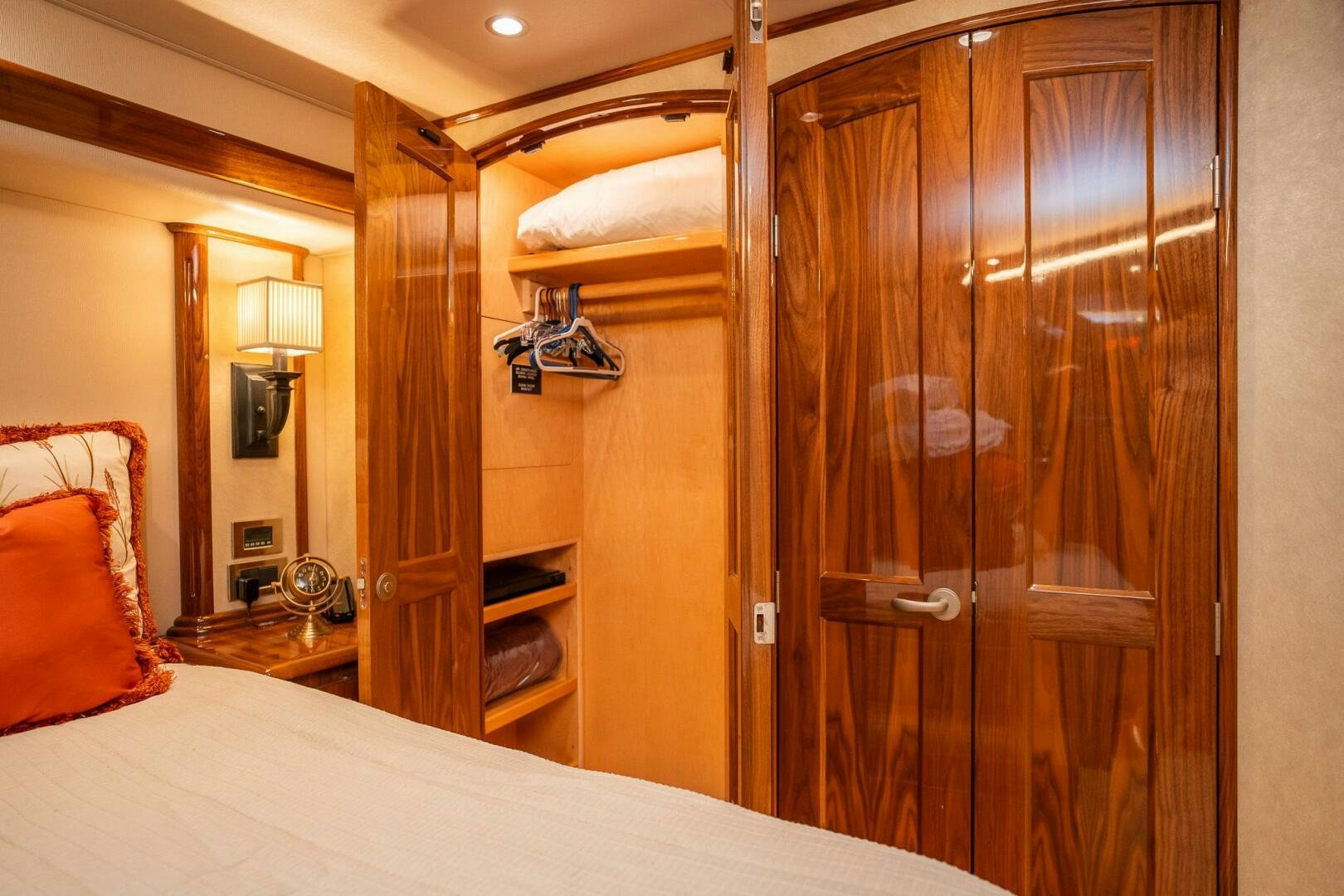 a bedroom with a wood closet aboard VOODOO Yacht for Sale