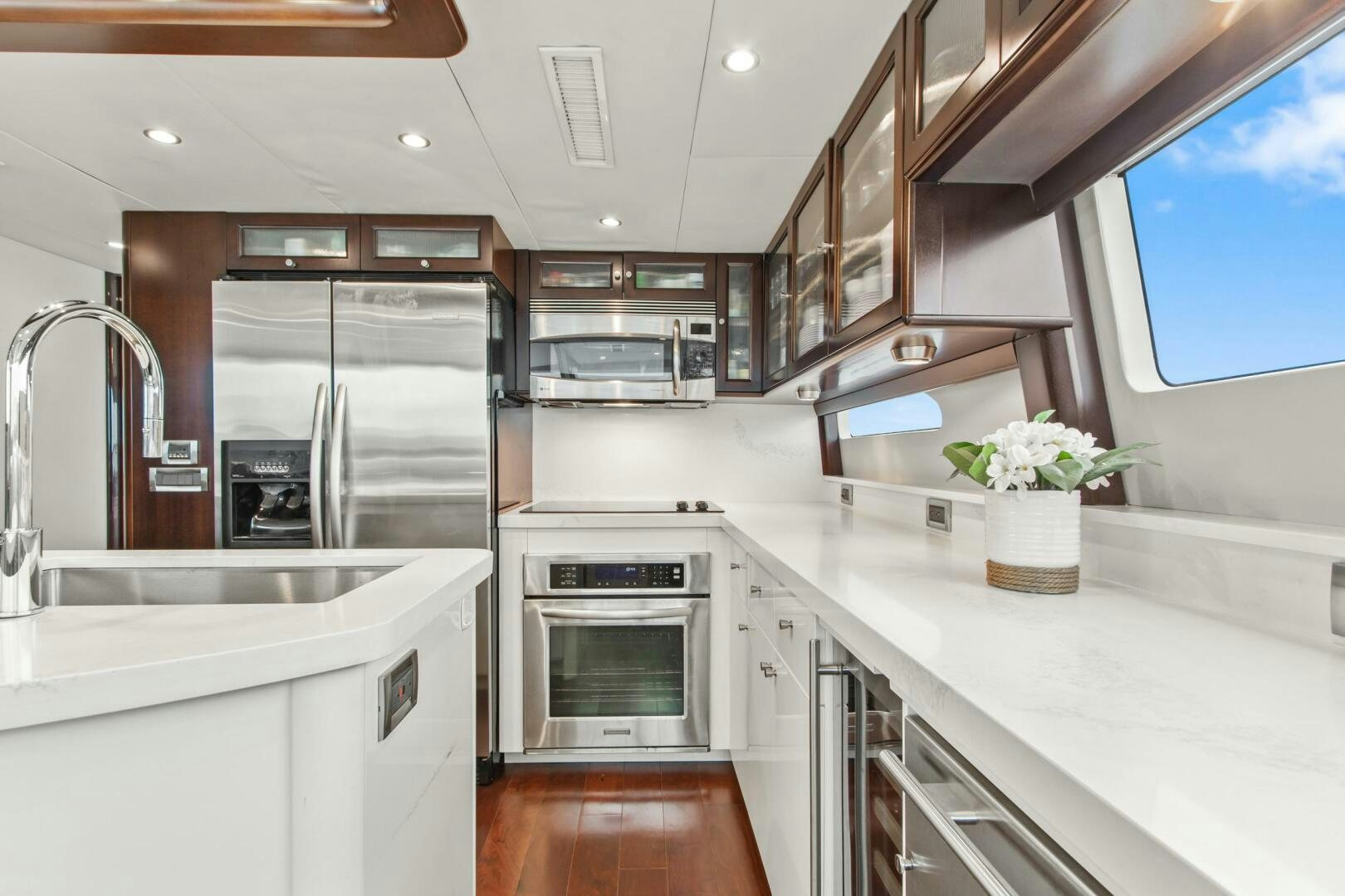 a kitchen with white cabinets aboard HIGH LIFE Yacht for Sale