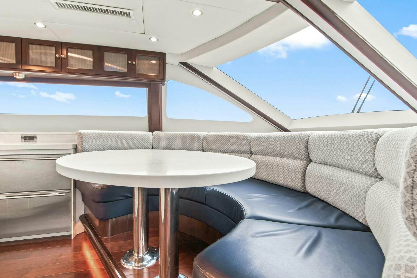 a room with a table and couch aboard HIGH LIFE Yacht for Sale