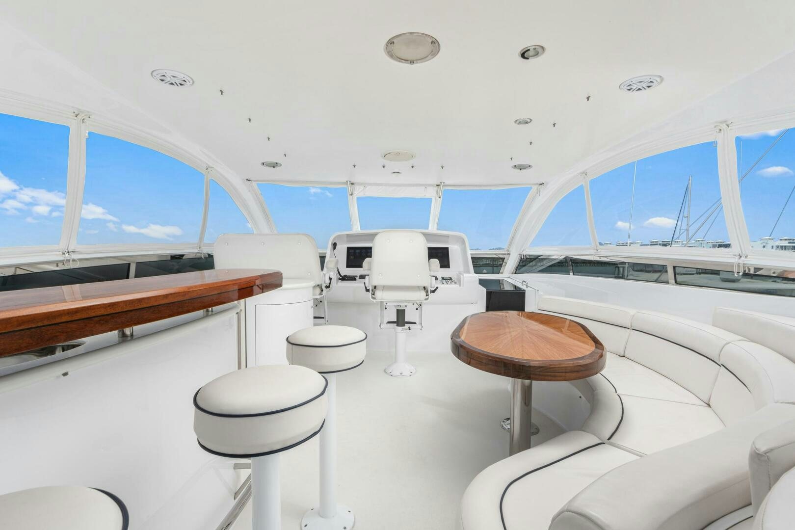a room with a table and stools aboard HIGH LIFE Yacht for Sale