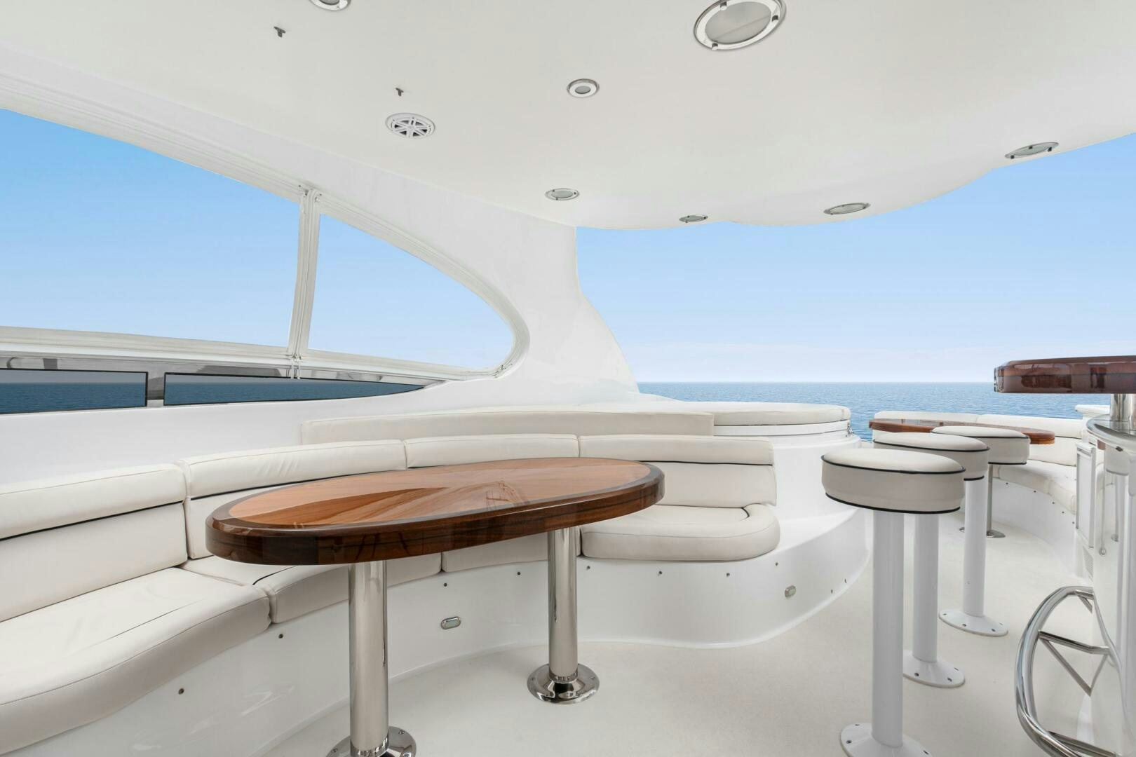 a table and chairs in a room aboard HIGH LIFE Yacht for Sale