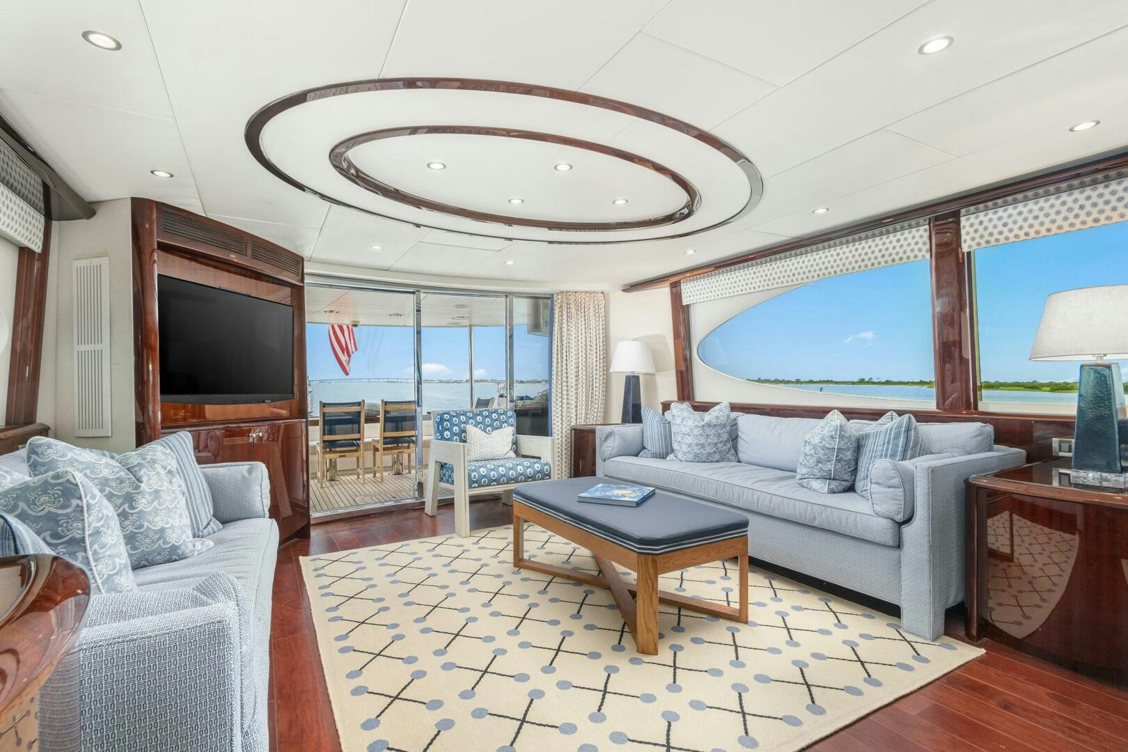 a living room with a large chandelier aboard HIGH LIFE Yacht for Sale