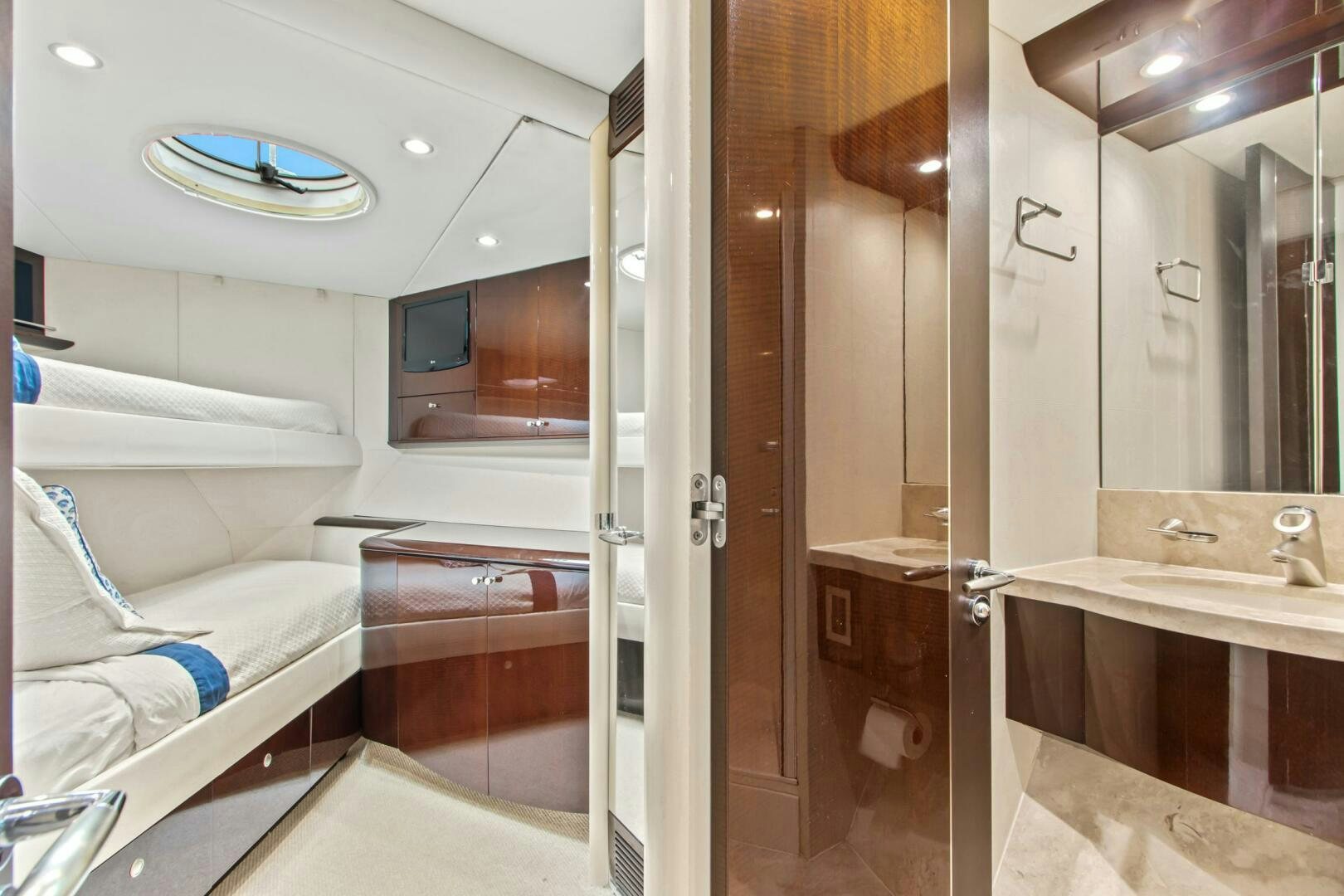 a bathroom with a sink and a bed aboard HIGH LIFE Yacht for Sale