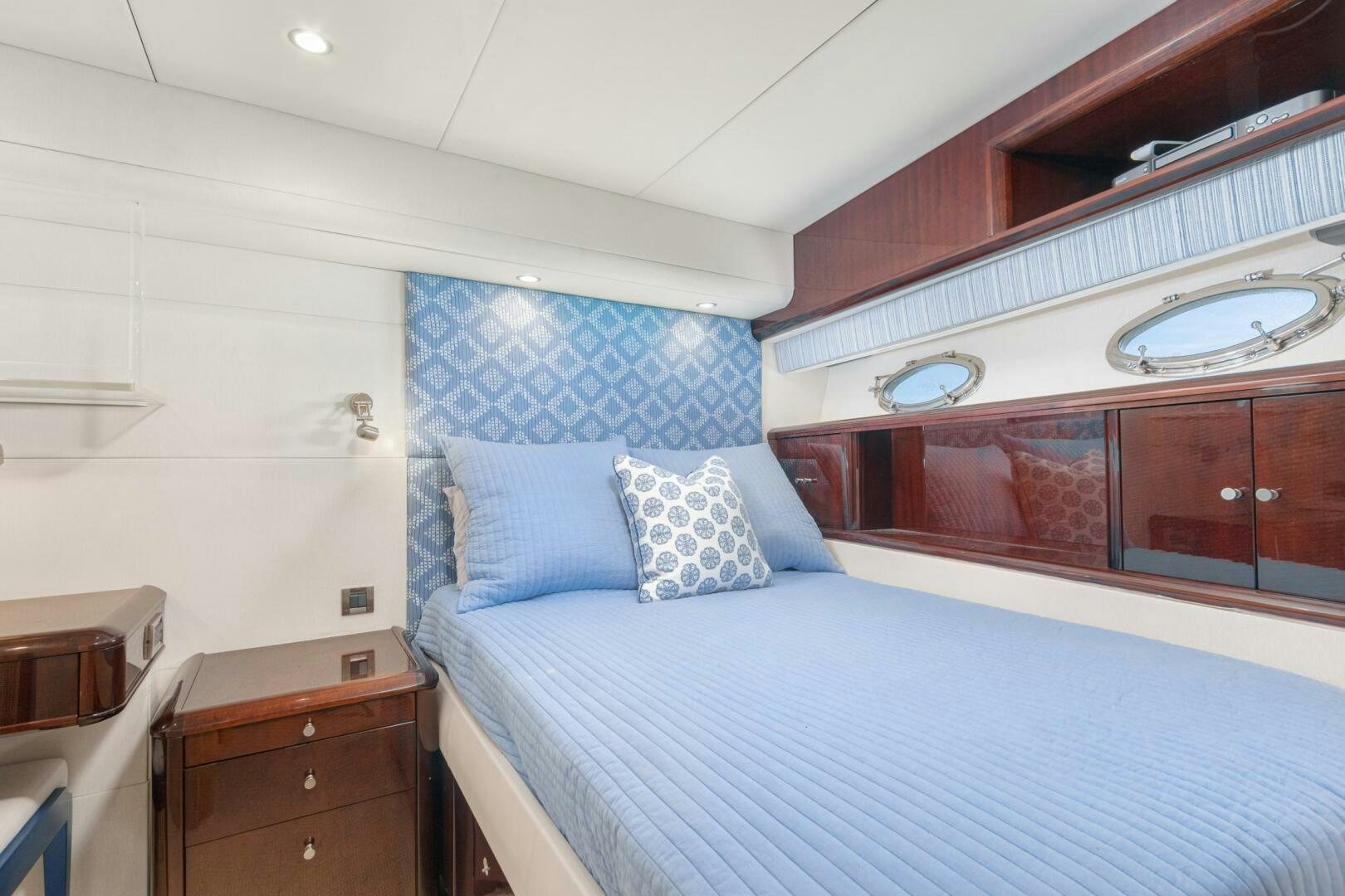 a bedroom with a bed and a dresser aboard HIGH LIFE Yacht for Sale