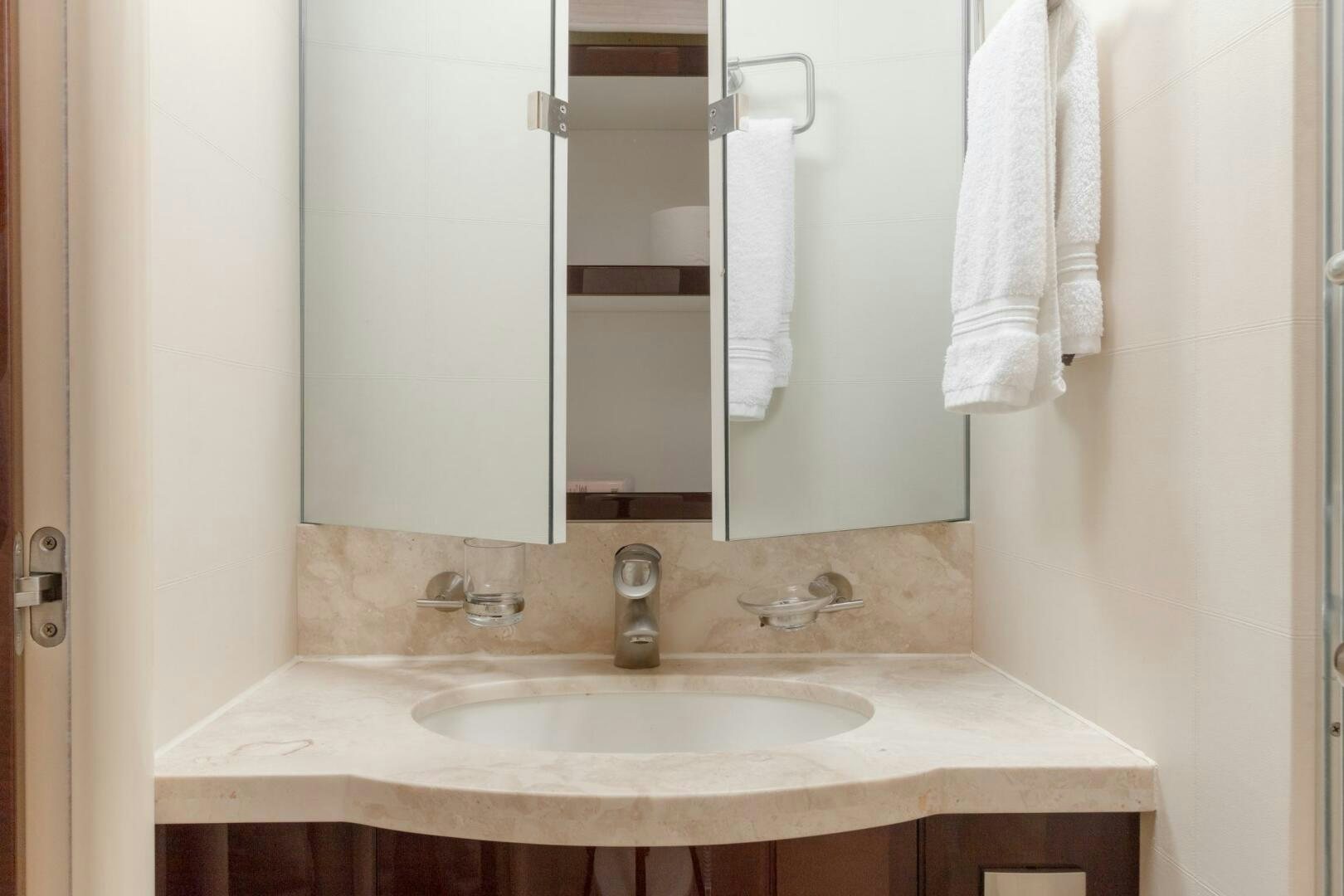 a bathroom with a sink and towels aboard HIGH LIFE Yacht for Sale