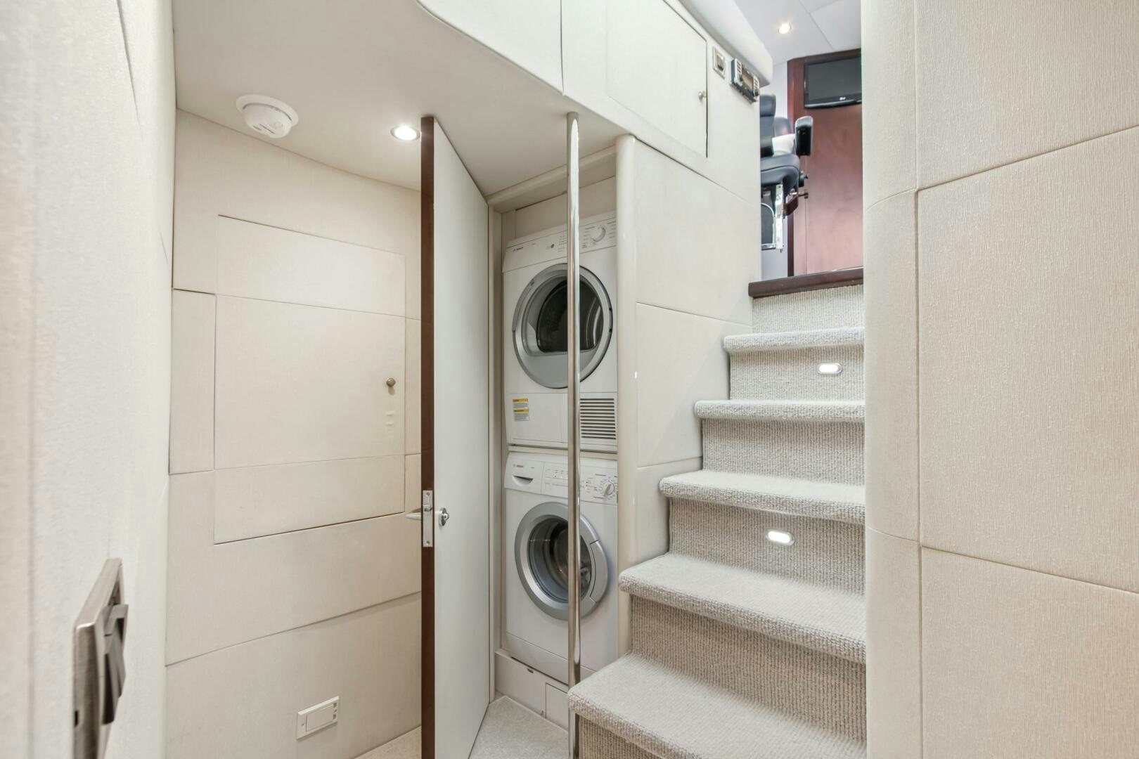 a bathroom with a toilet and a washer aboard HIGH LIFE Yacht for Sale
