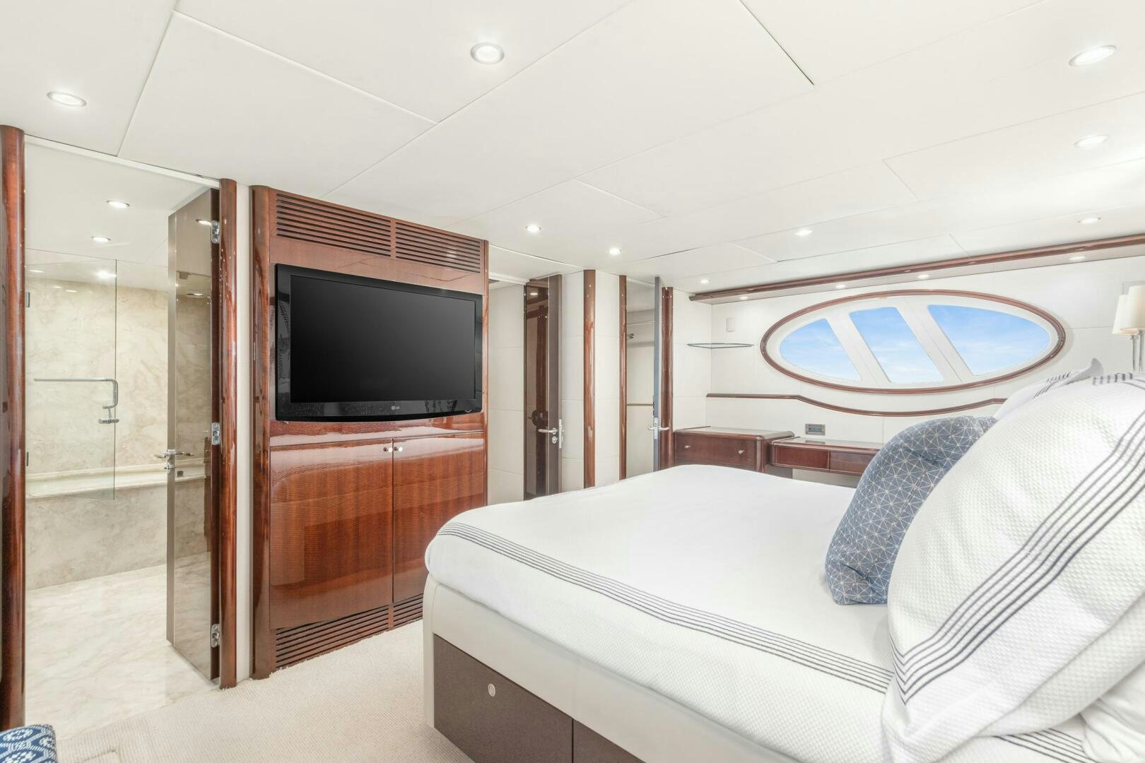 a bedroom with a bed and a television aboard HIGH LIFE Yacht for Sale