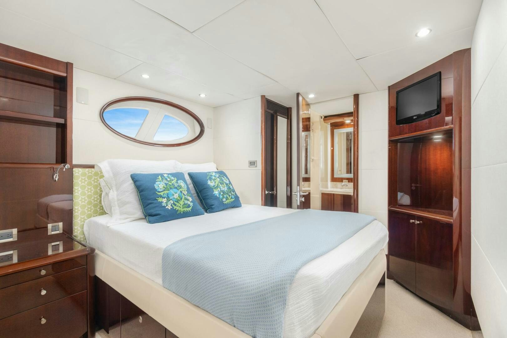 a bedroom with a bed and a television aboard HIGH LIFE Yacht for Sale