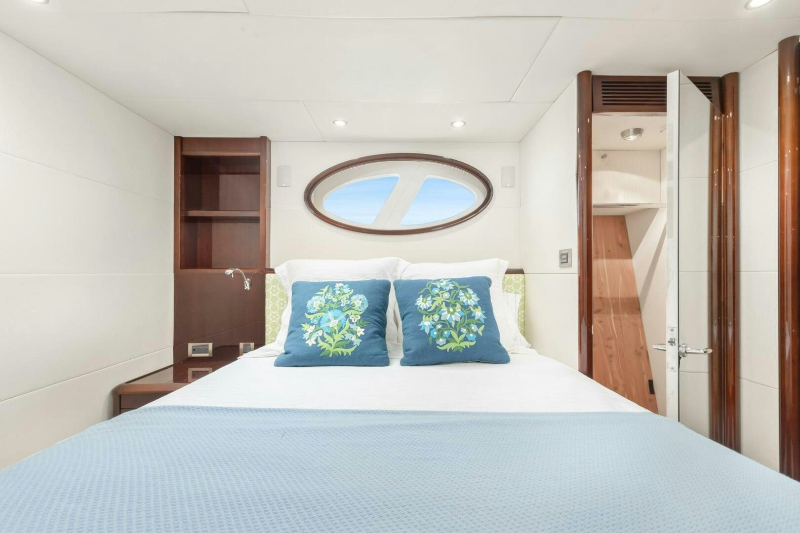 a bed with blue and white sheets aboard HIGH LIFE Yacht for Sale