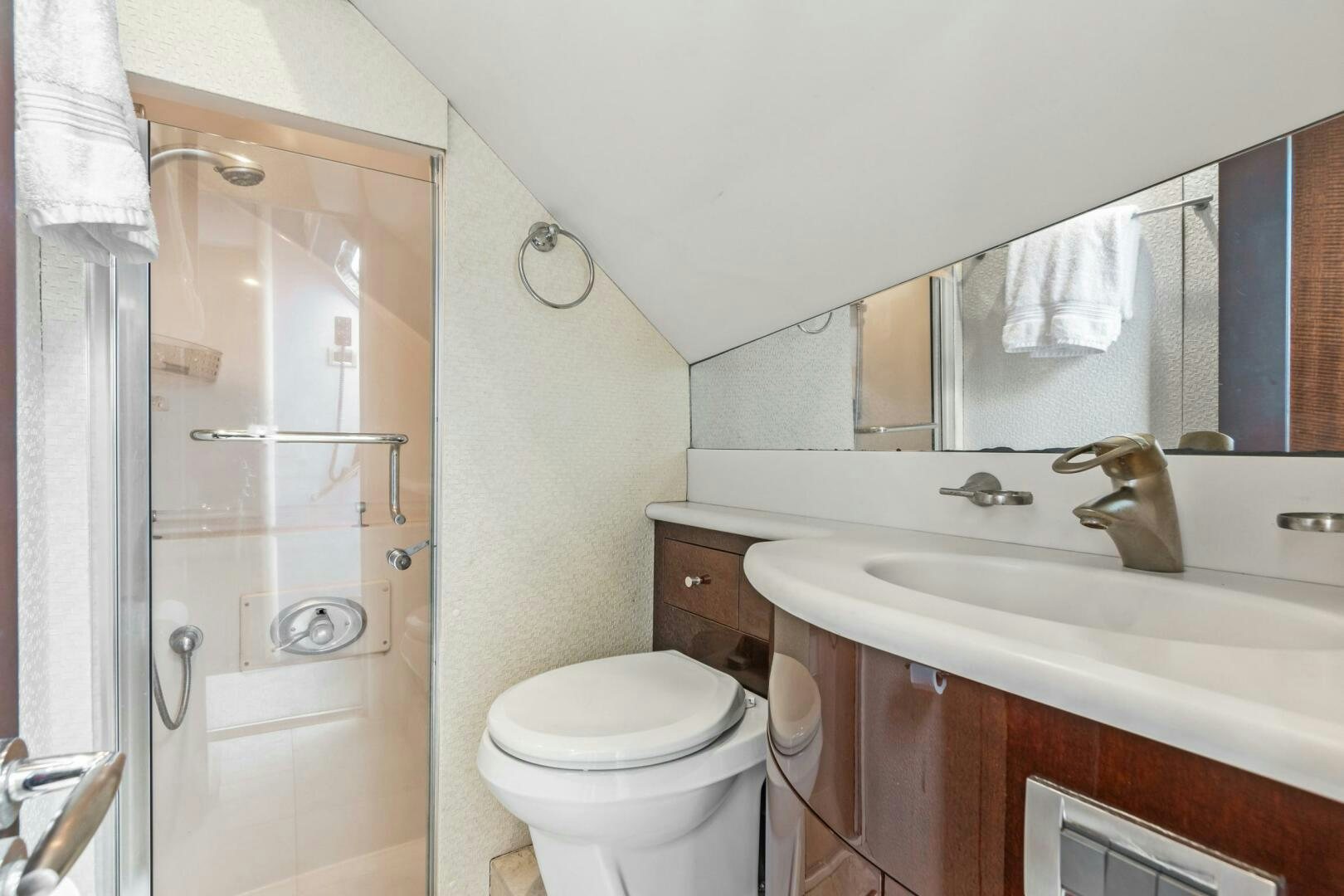 a bathroom with a toilet sink and a mirror aboard HIGH LIFE Yacht for Sale