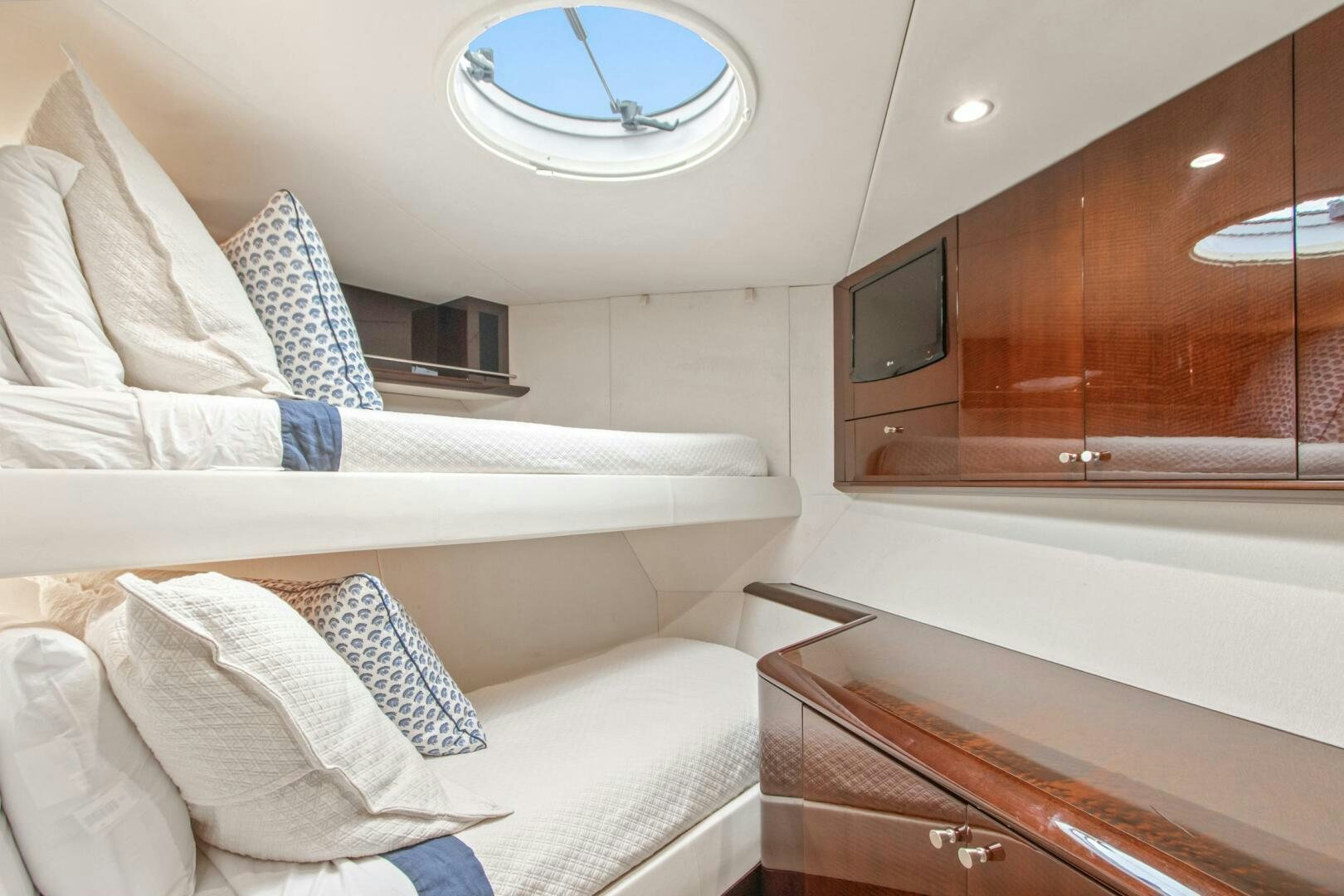 a room with a bed and a television aboard HIGH LIFE Yacht for Sale