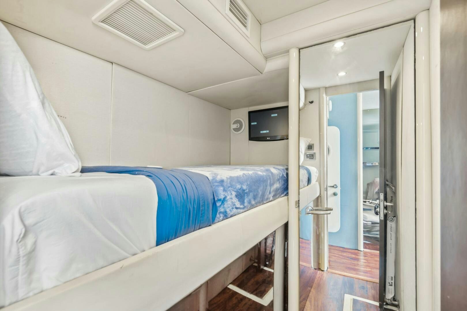 a room with a bed and a television aboard HIGH LIFE Yacht for Sale