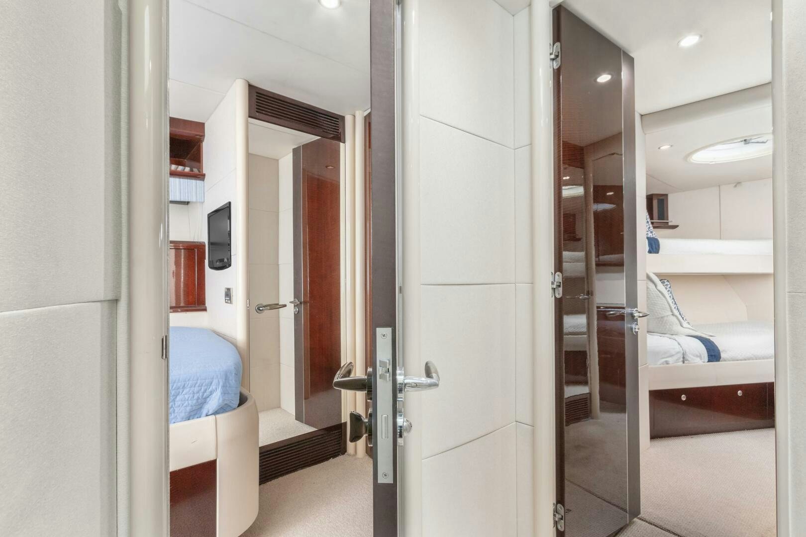 a room with a bed and a door aboard HIGH LIFE Yacht for Sale