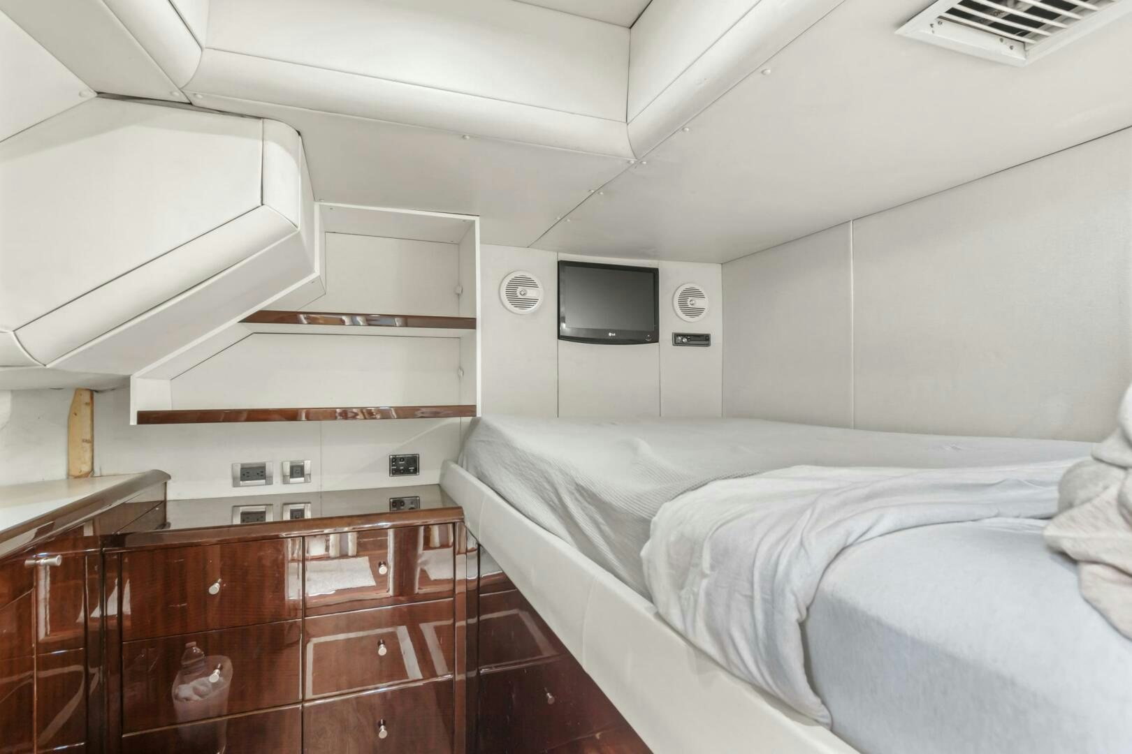 a room with a bed and a television aboard HIGH LIFE Yacht for Sale