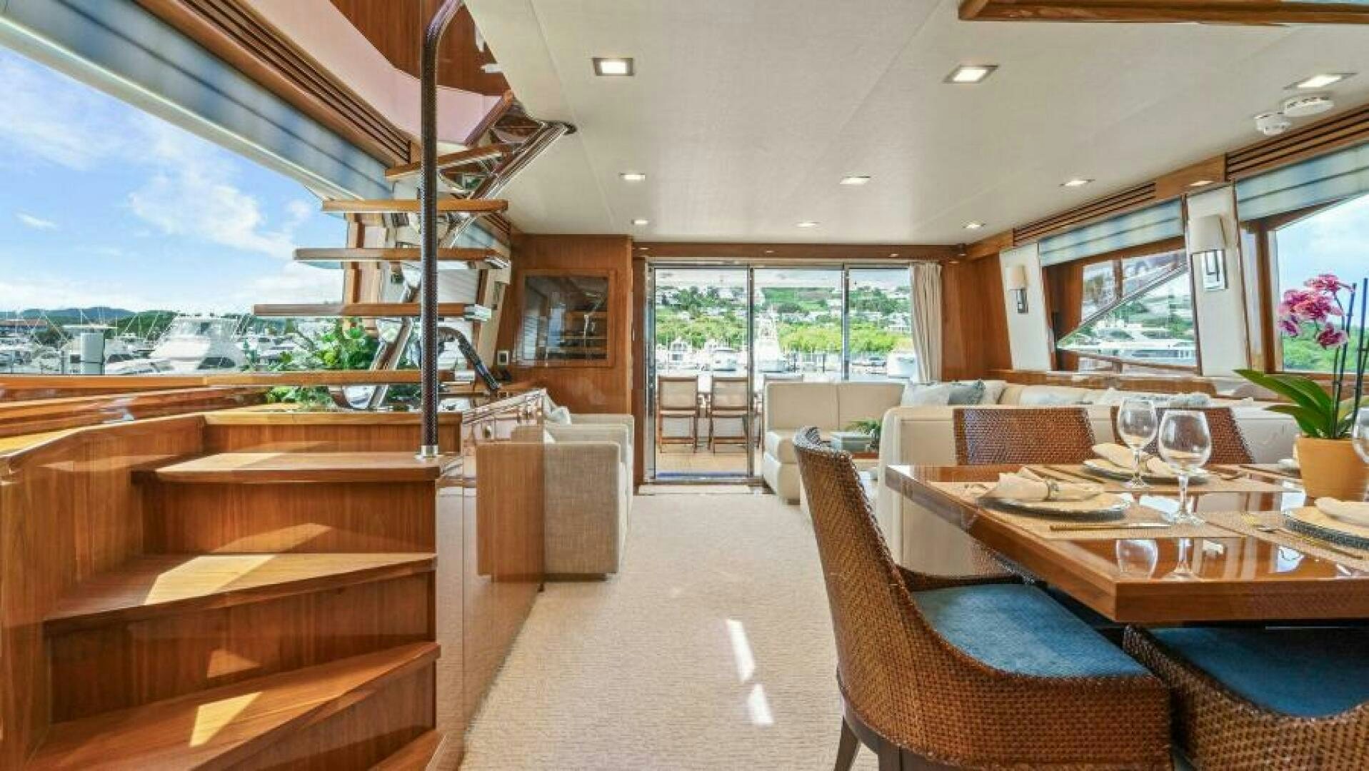 a large dining room with a wood table and chairs aboard AMORE Yacht for Sale
