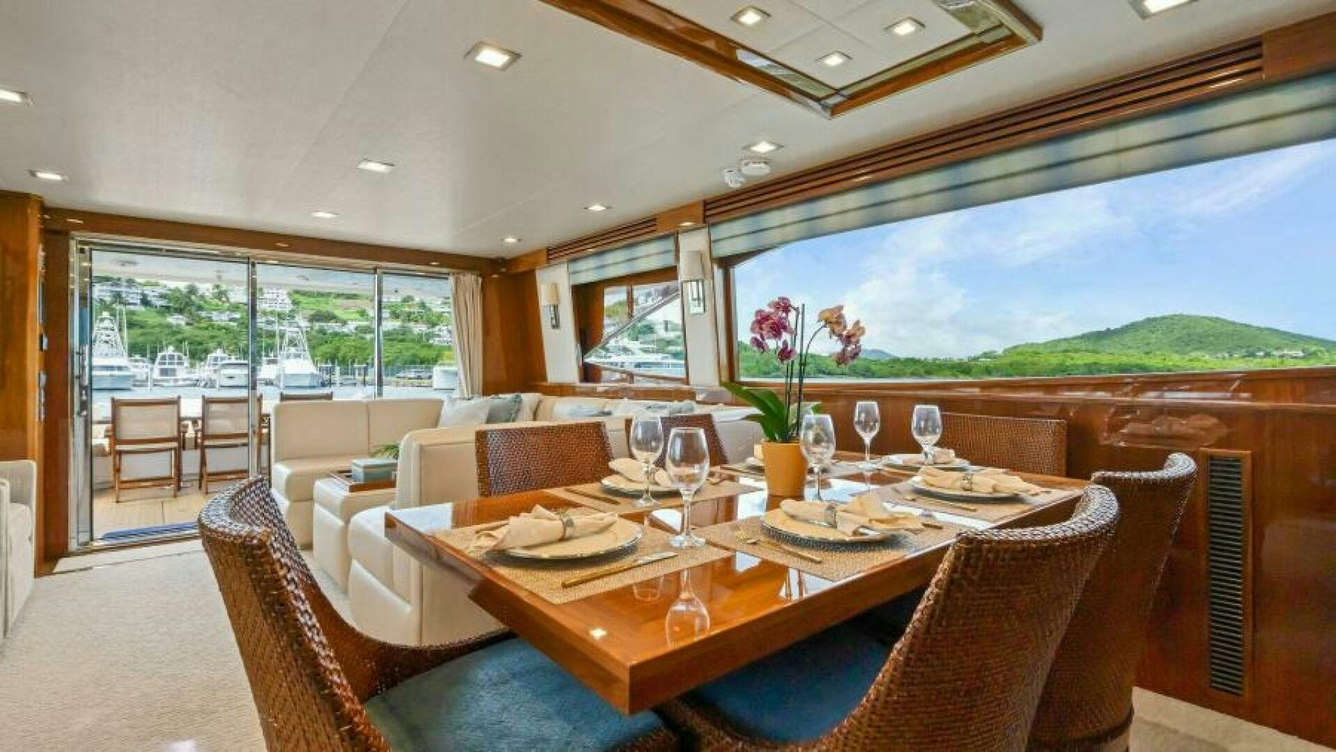 a dining room with a large window aboard AMORE Yacht for Sale