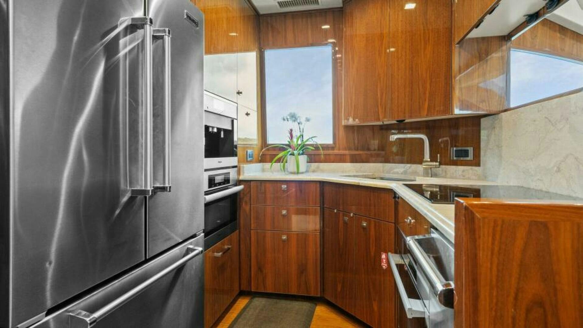 a kitchen with wooden cabinets aboard AMORE Yacht for Sale
