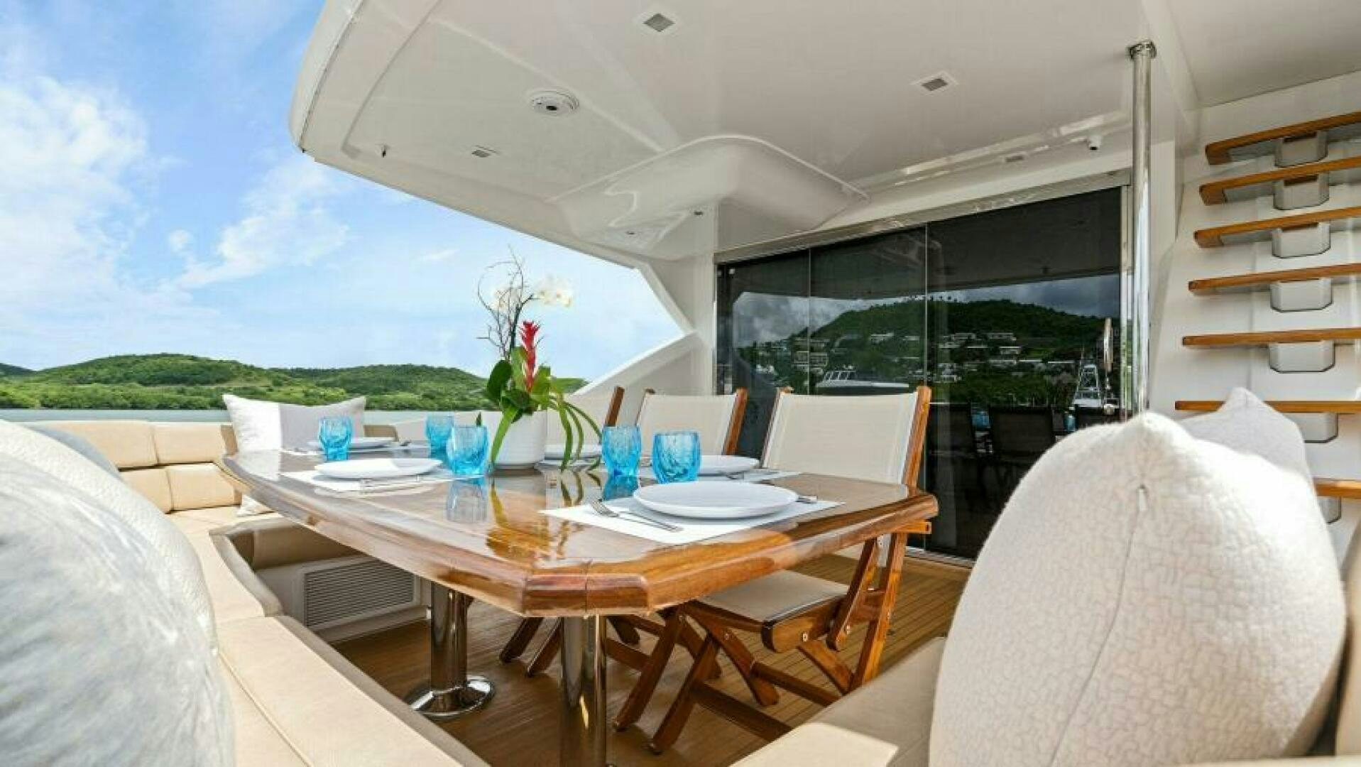 a table with chairs and a couch aboard AMORE Yacht for Sale