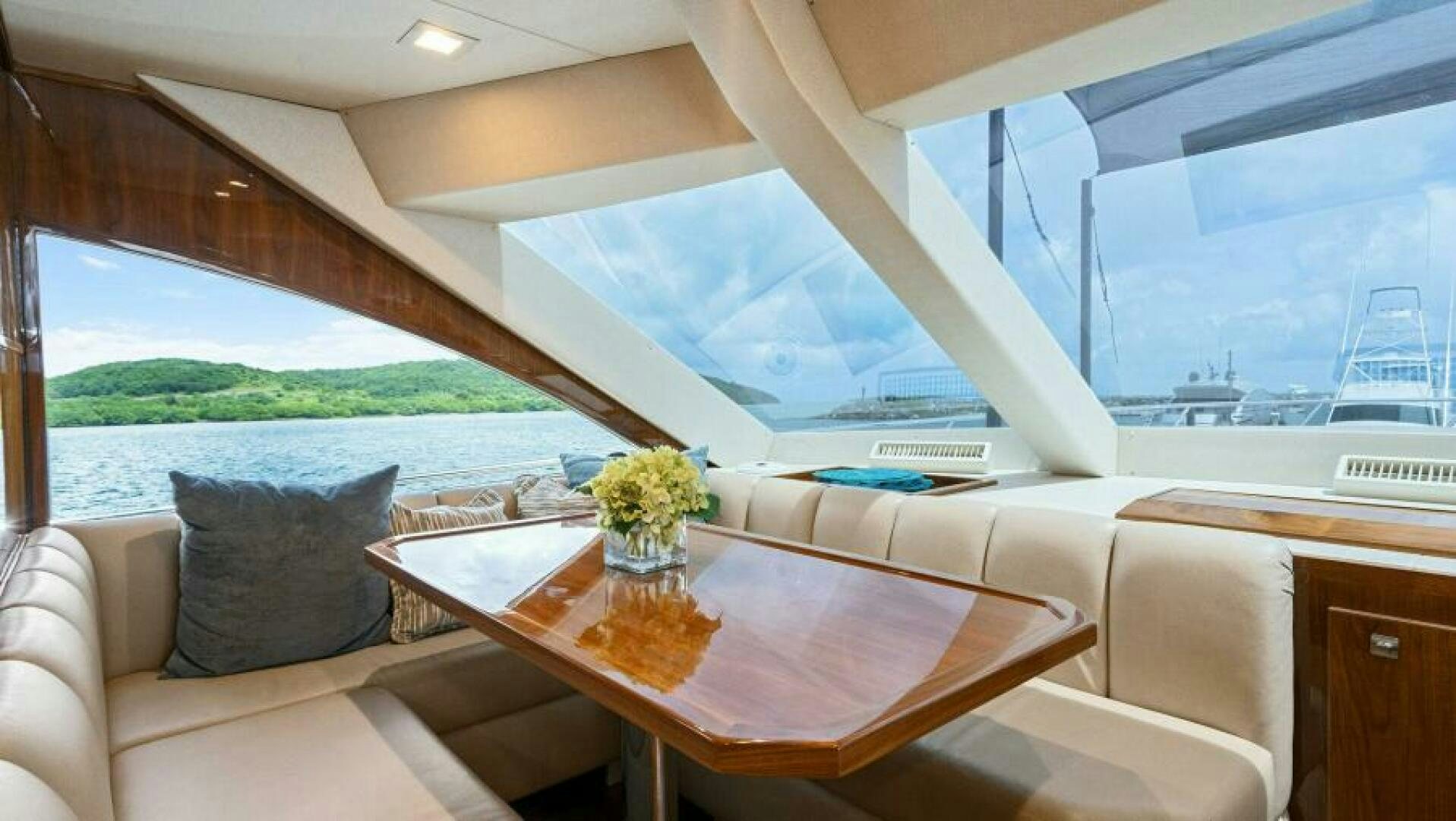 a room with a table and chairs aboard AMORE Yacht for Sale