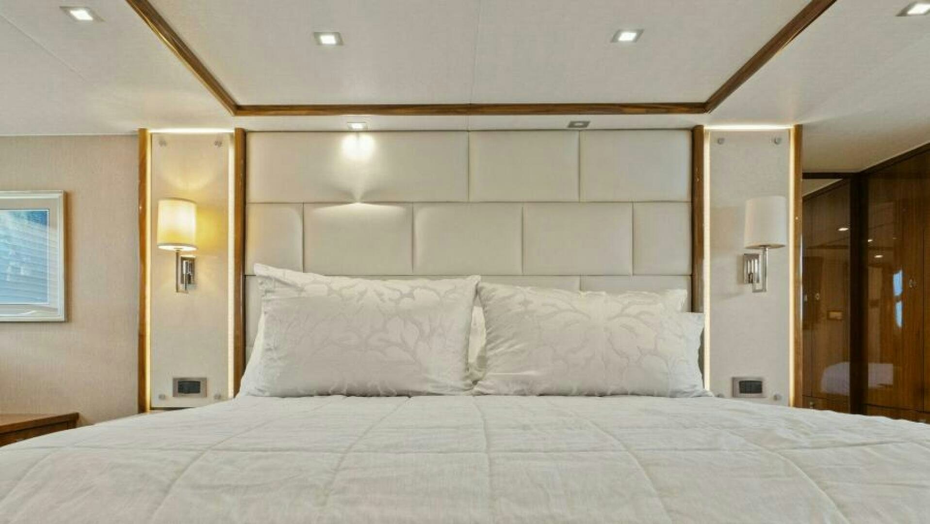 a large bed with white sheets aboard AMORE Yacht for Sale