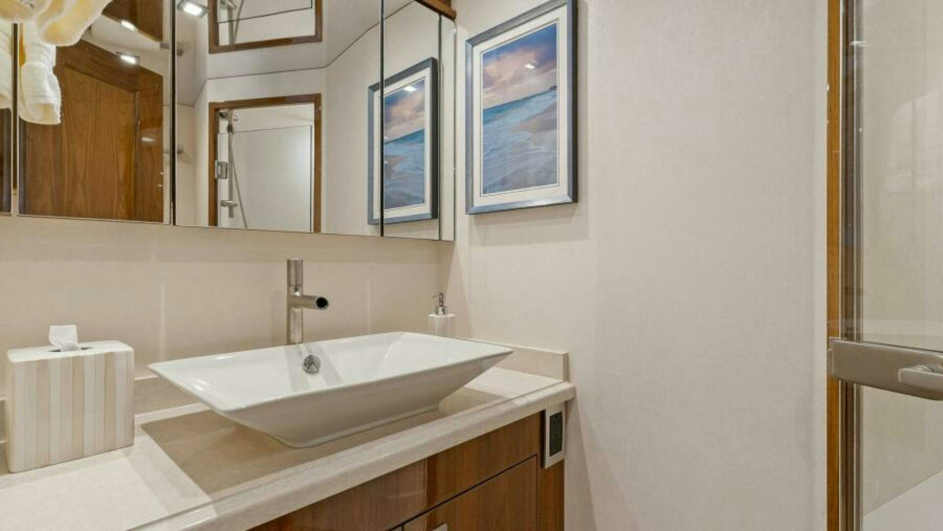 a bathroom with a sink and mirror aboard AMORE Yacht for Sale