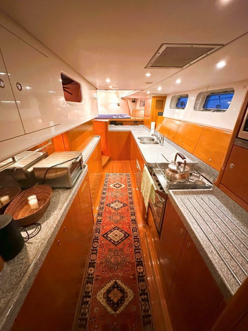 a kitchen with a large island aboard LEONORE Yacht for Sale