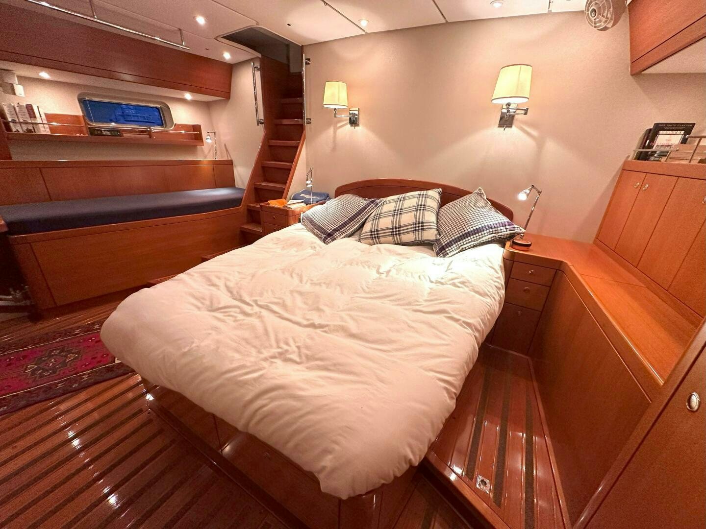a bedroom with a bed and a desk aboard LEONORE Yacht for Sale