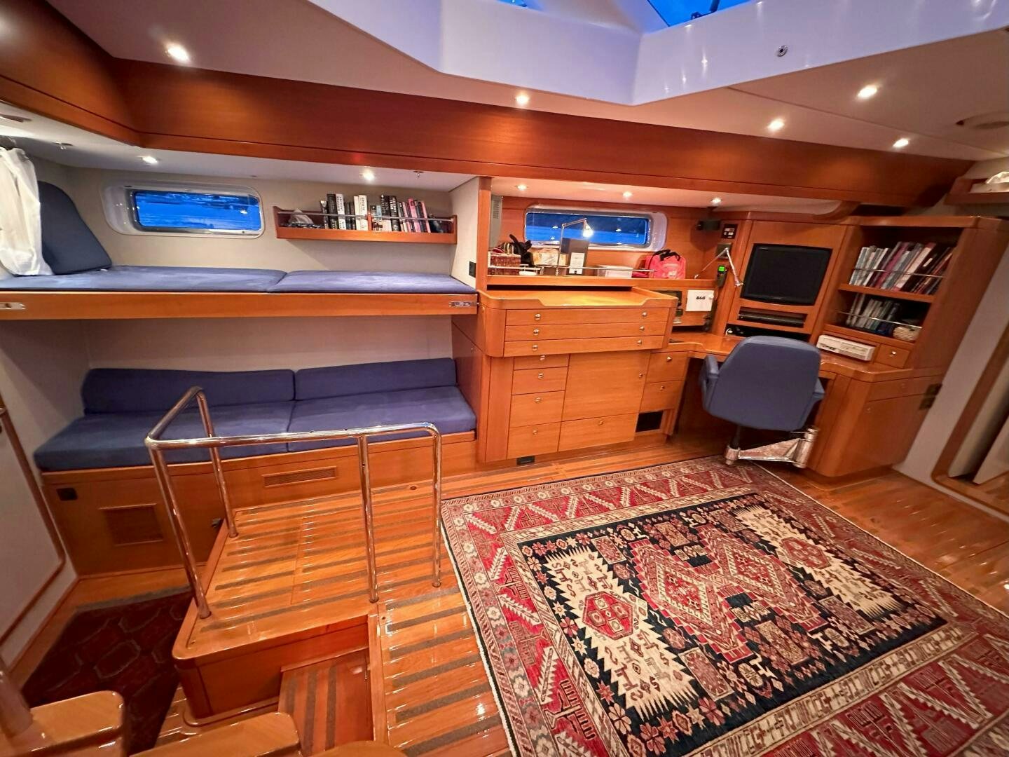 a room with a bed and desk aboard LEONORE Yacht for Sale