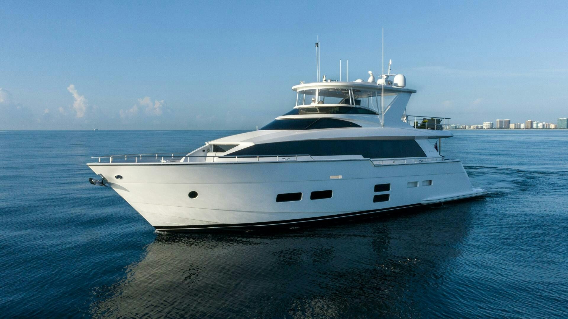 a white yacht in the water aboard IMAGINE Yacht for Sale
