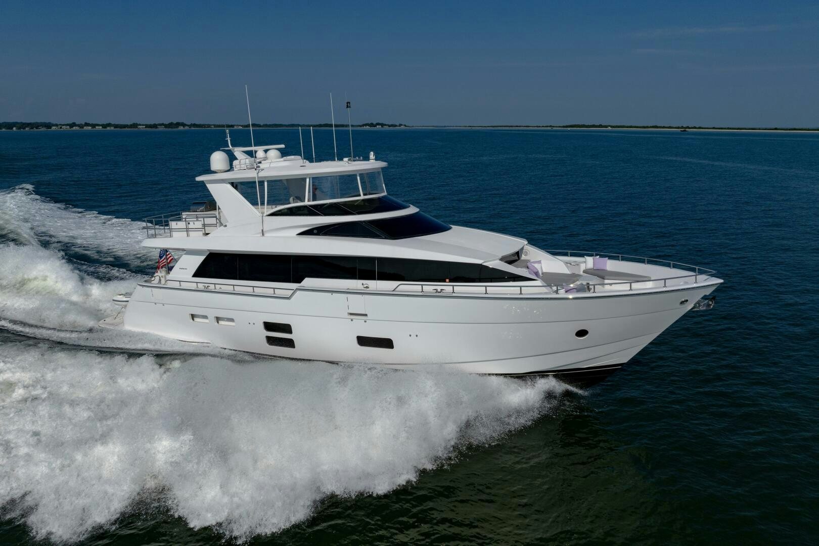 a white yacht on the water aboard IMAGINE Yacht for Sale