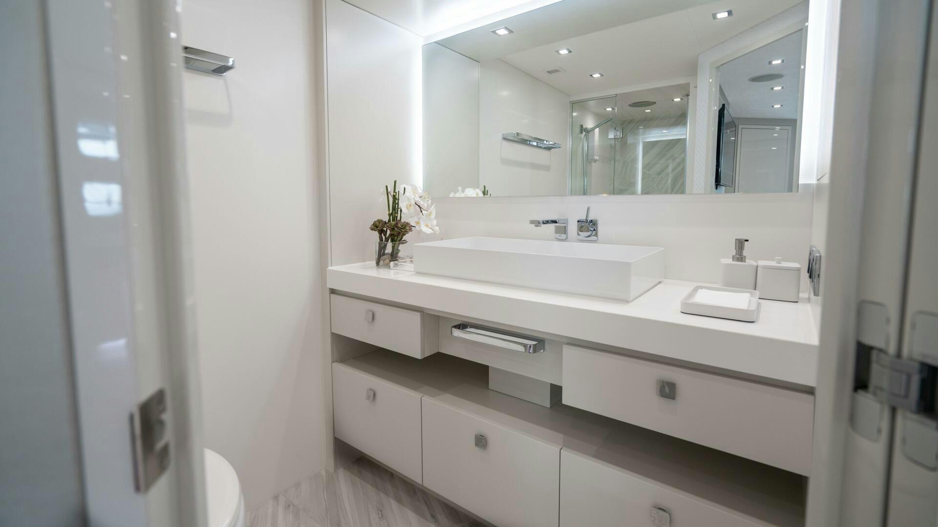 a bathroom with a large mirror aboard IMAGINE Yacht for Sale